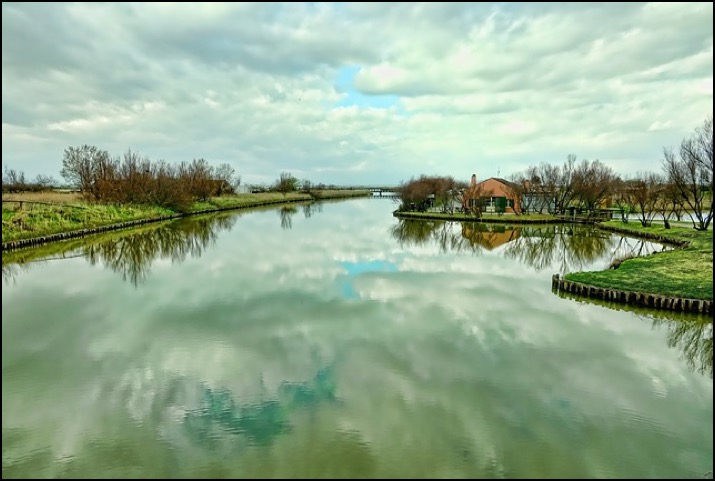 River with banks and house