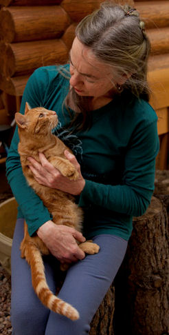 Woman and orange tabby cat looking at each other