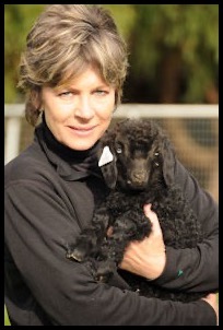 Woman holding black dog