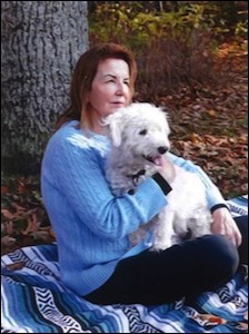 Women sitting under tree with white dog