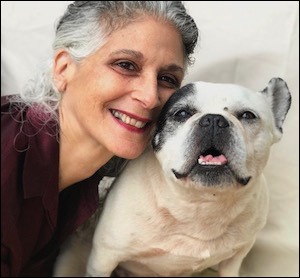Woman leaning against French Bulldog