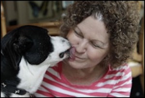 Dog kissing woman