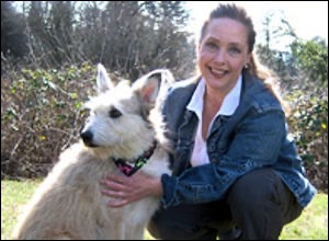 woman holding white terrier dog