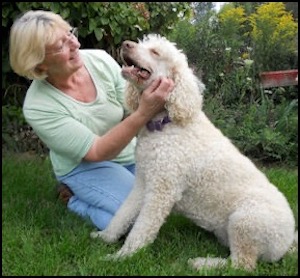 Woman holding white poodle dog