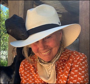 Woman in hat with goat