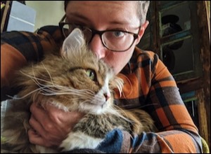 Woman behind cat in arms