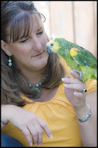 Woman holding parrot on hand